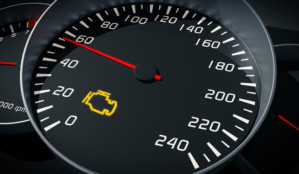 A closeup image of a vehicle's speedometer with the needle on 56 and the check engine light on.